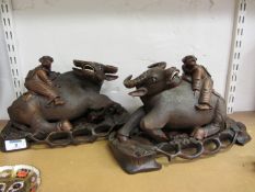 Pair of 20th century carved hardwood buffaloes on carved pierced bases L30cm