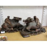 Pair of 20th century carved hardwood buffaloes on carved pierced bases L30cm