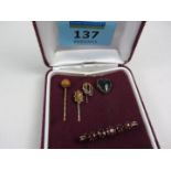 Four Victorian and later stick pins and a brooch (tested for gold)