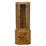 Yorkshire adzed oak 'Mouseman' floor standing corner cupboard enclosed by lead glazed door above