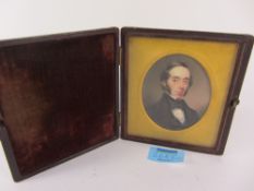 19th century oval portrait miniature on ivory in hinged velvet lined leather case 7cm x 7cm