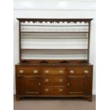 George III oak dresser fitted with four mahogany crossbanded drawers and two cupboards,