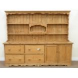 Large Victorian waxed pine dresser fitted with four drawers and cupboard with two tier plate rack,
