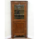 George III inlaid mahogany floor standing two sectional corner display cabinet,