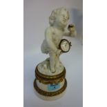 Mid 19th century table clock in the form of a Parian cherub carrying a drum set with watch type