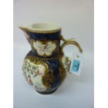 First Period Worcester porcelain jug, scale blue cabbage leaf moulded body with mask-head spout,