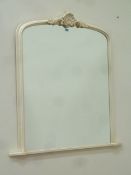 Arch top overmantle mirror in ivory frame with carved pediment,