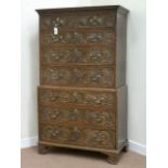 Early 19th century heavily carved oak chest on chest fitted with two short and six long drawers,