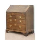 George III oak fall front bureau fitted with two short and two long drawers,