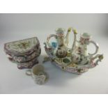 Early 20th century French faience cruet set and stand, similar four drawer bombe commode chest and a