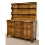 Ercol golden dawn elm dresser fitted with four drawers and two cupboards,