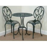 Ornate wrought metal circular garden table and two garden chairs, D61cm,