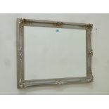 Rectangular bevelled edge wall mirror in silvered swept frame,