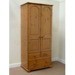 Pine double wardrobe with three drawers,
