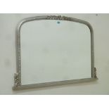 Arch top overmantle mirror in silvered frame with bevelled glass,