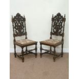 Pair Victorian heavily carved oak hall chairs