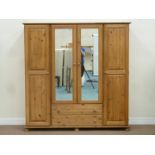 Solid pine four door wardrobe with two drawers,