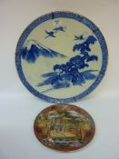 19th/20th century Japanese blue and white charger decorated with cranes in a mountainous landscape