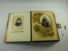 Victorian photograph album with musical mechanism, the pages decorated with sporting scenes,