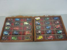 Thirty die-cast advertising vans in two display cabinets