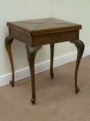 Late Victorian walnut card table, envelope swivel top revealing counter wells and inset baize,