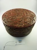 Chinese cinnabar lacquer box and cover of circular form carved with flowers and foliage, the base