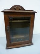 Early 20th century oak smokers cabinet with bevelled glass door H35cm