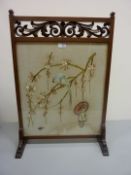 Early 20th century mahogany fire screen with pierced carving and oriental embroidery panel H73cm