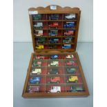 Thirty die-cast advertising vans in two display cabinets