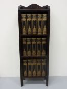 Fifteen Dickens novels in narrow mahogany bookcase H93cm x 31cm