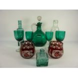 Edwardian green glass claret decanter, four similar glasses,