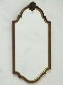 Early 20th century mahogany shaped frame wall mirror with gilt and carved detail, bevelled glass,