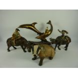 Two oriental sculptures of children riding water buffaloes,