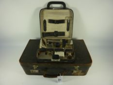 Vintage suitcase fitted with vanity case and contents of chrome backed brushes,