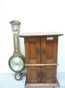 Early 20th century oak cabinet enclosed by four panelled doors H56cm and an oak barometer