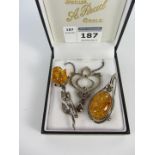 Two amber brooches and a stone set marcasite necklace all stamped 925