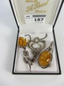 Two amber brooches and a stone set marcasite necklace all stamped 925