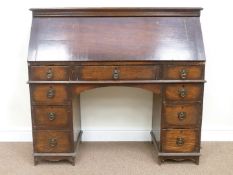 Early 20th century oak twin pedestal desk, fall front above nine drawers,