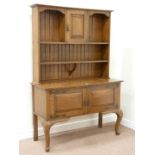 Early 20th century oak dresser fitted with two cupboards and plate rack, W129cm,