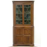 George III oak corner cabinet enclosed by two astragal glazed doors fitted with three shelves,