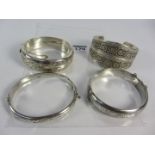 Three vintage hallmarked silver hinged bangles and a blind filligree bangle