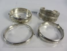 Three vintage hallmarked silver hinged bangles and a blind filligree bangle