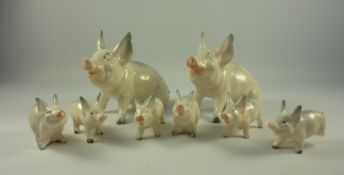 Two Beswick seated pigs and six miniature Beswick pigs