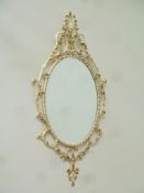 Bevelled edge oval mirror in ornate cream and gilt metal frame H95cm