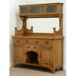 Early 20th century golden oak Arts and Crafts oak bevelled mirror back sideboard fitted with three