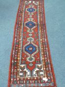 Persian red ground runner rug,