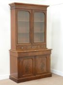 Victorian mahogany bookcase enclosed by two glazed doors above three drawers on chiffonier fitted