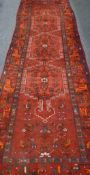 Afghan triple medallion red ground runner rug,