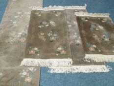 Group of four Chinese washed woollen green pattern self embossed rugs (241cm x 69cm),