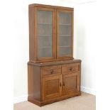 Late Victorian walnut bookcase enclosed by two glazed doors on cupboard fitted with two drawers and